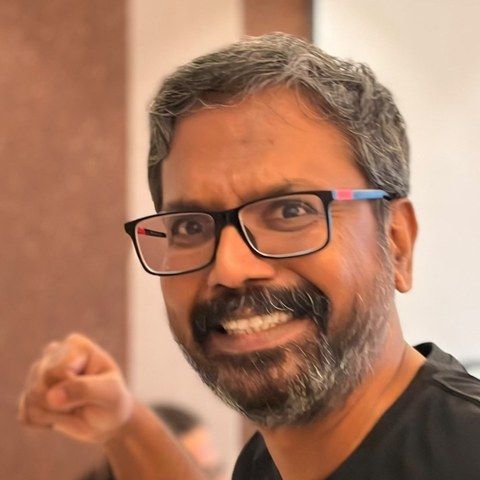 Shemeer, smiling, with a raised fist